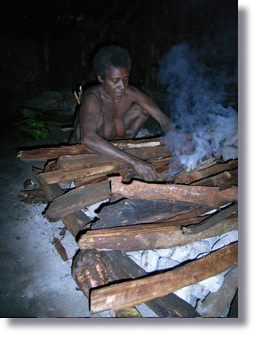 Late chief's wife Irene prepare fire for their dinner